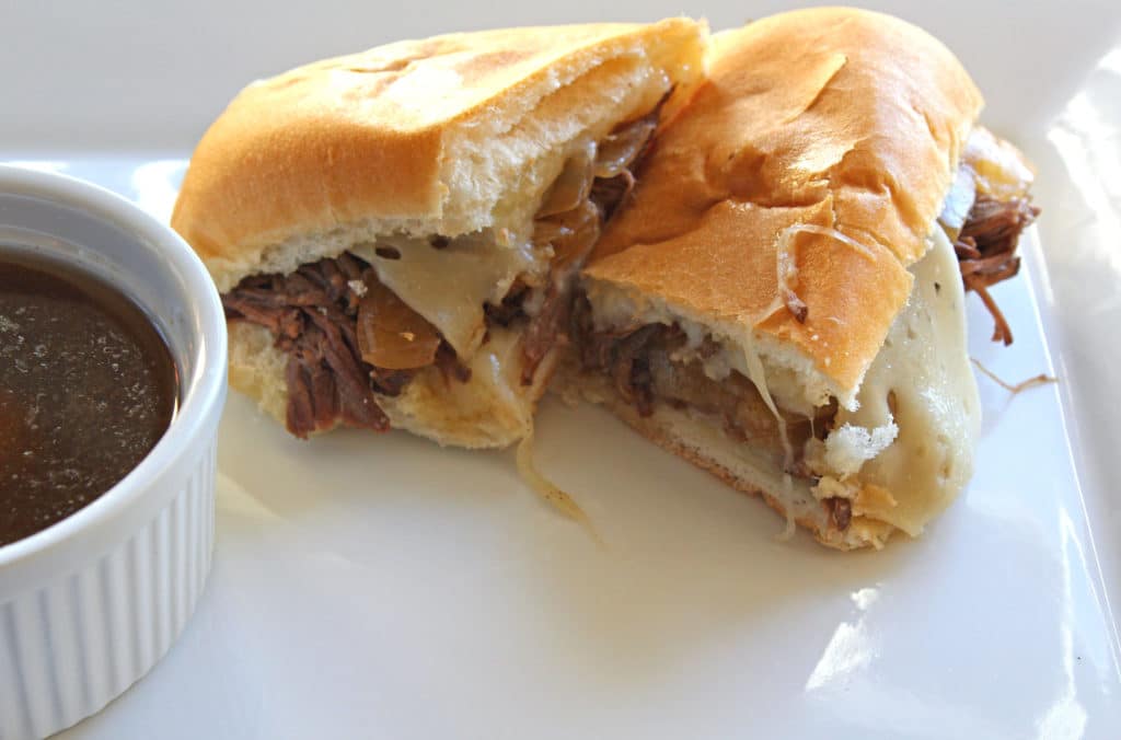 sliced French Dip Sandwich on plate