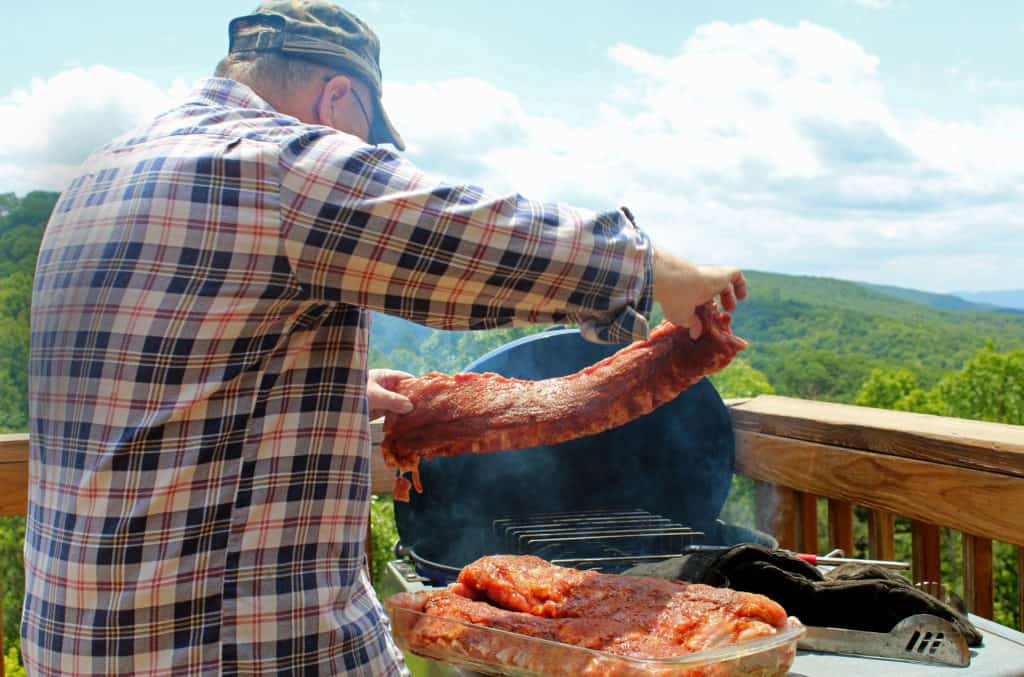 David placing ribs on the grill