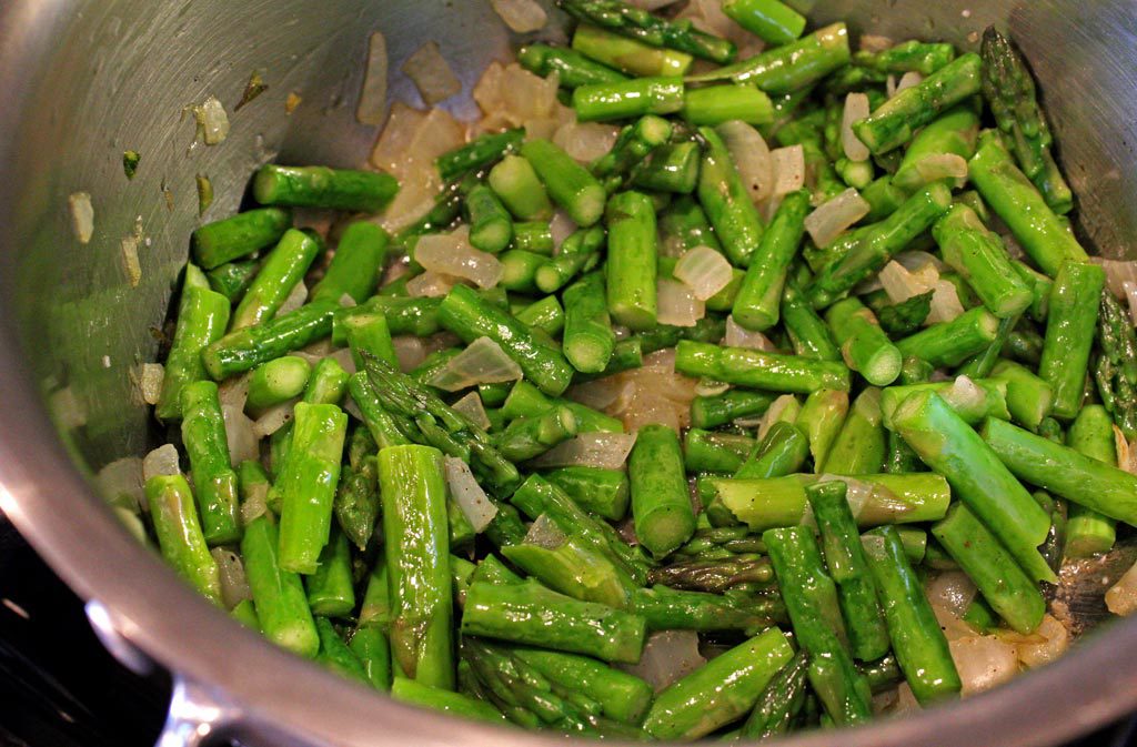 asparagus and onions cooking in pot