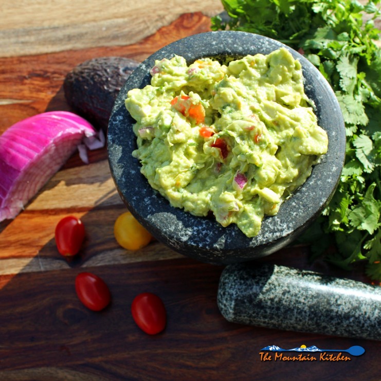 prepared guacamole in mortar bowl
