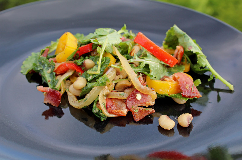 kale salad with peas on plate with mountain view
