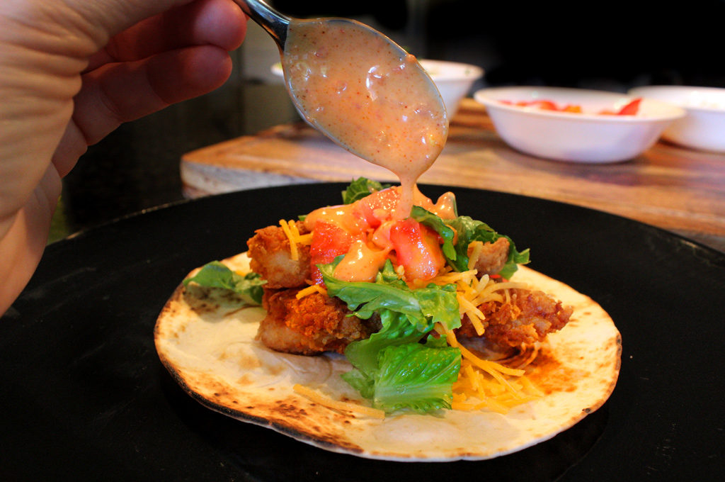 drizzling sauce into wrap