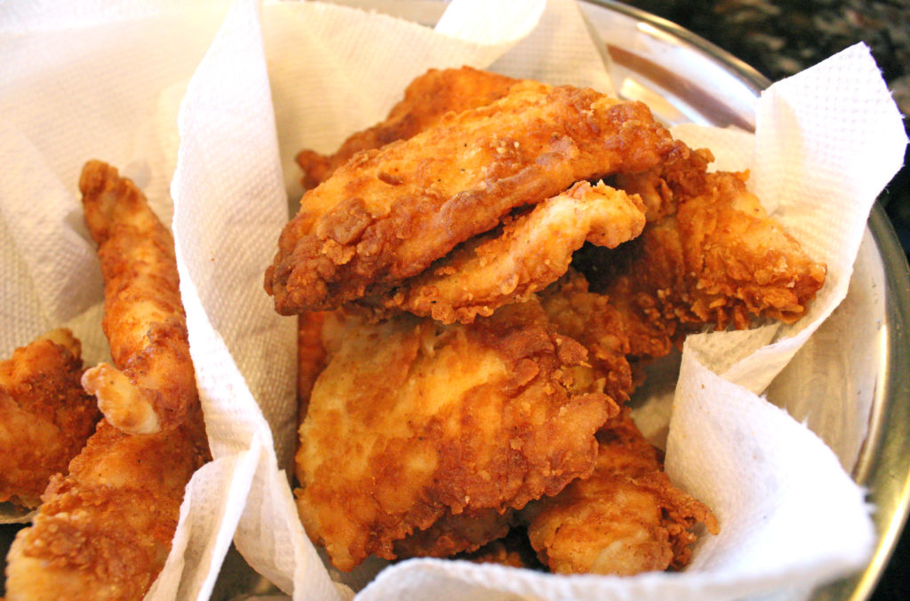 fried chicken tenders draining