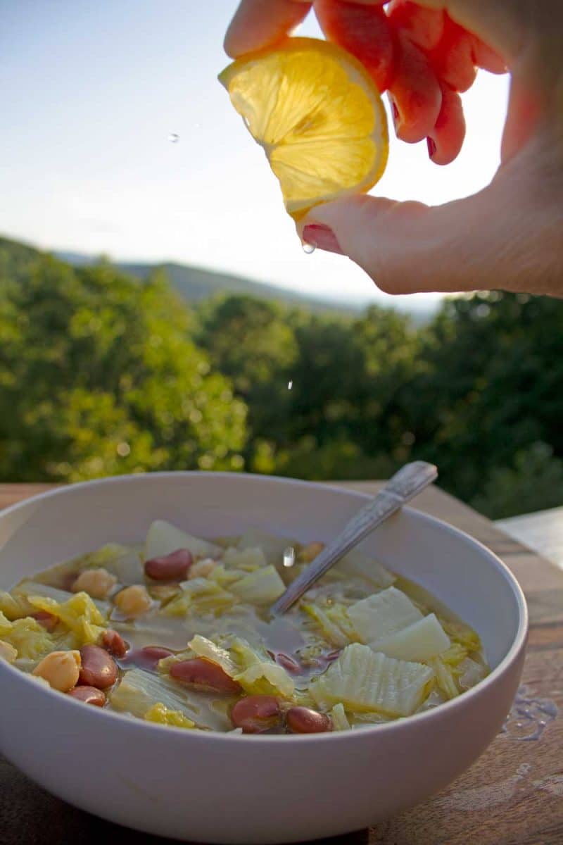 squeezing lemon into bowl of soup