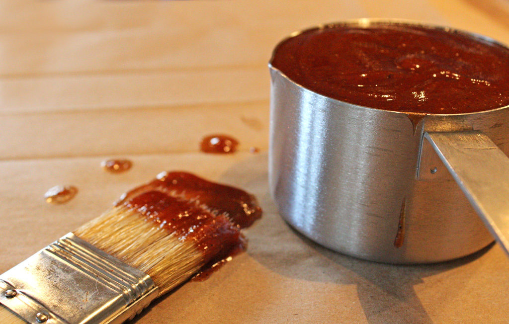 classic barbecue sauce in measuring cut with saucy brush
