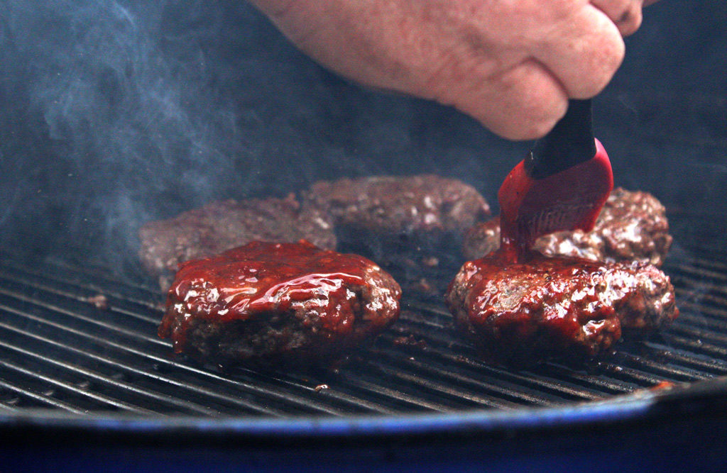 basting sauce on burgers