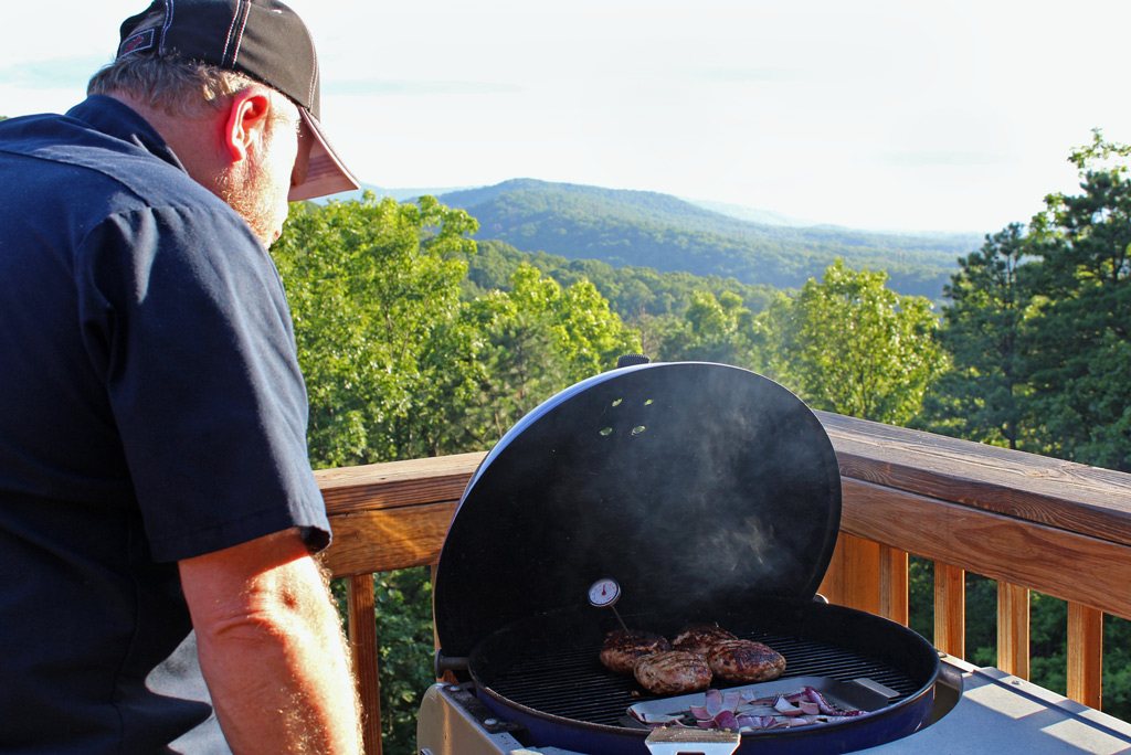David watching grill with mountain view in background