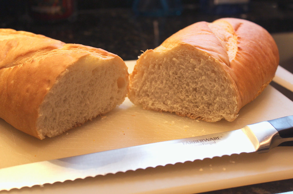 sliced bread on cutting board with knife