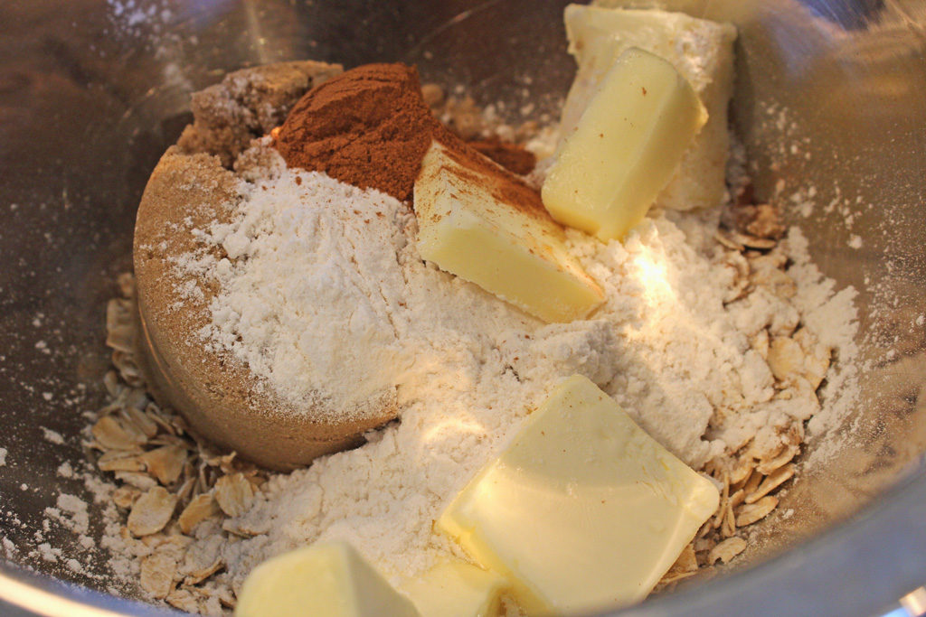 butter sugar flour and oats inside bowl for peach crisp