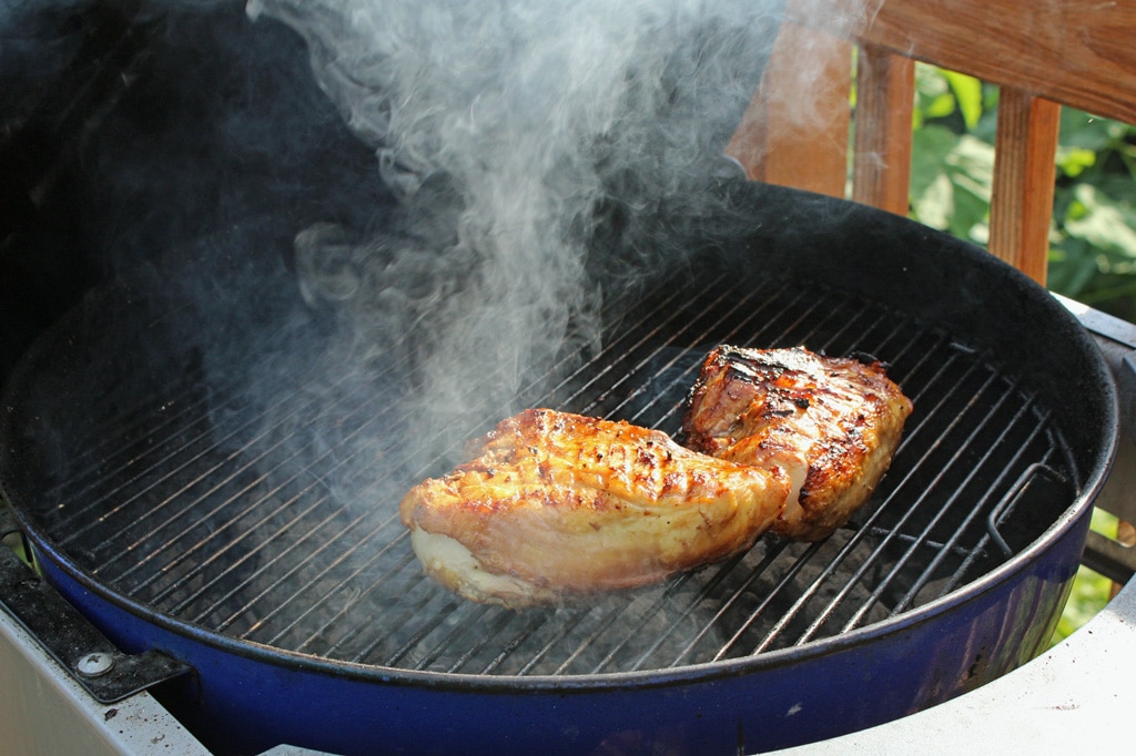 chicken grilling on charcoal grill