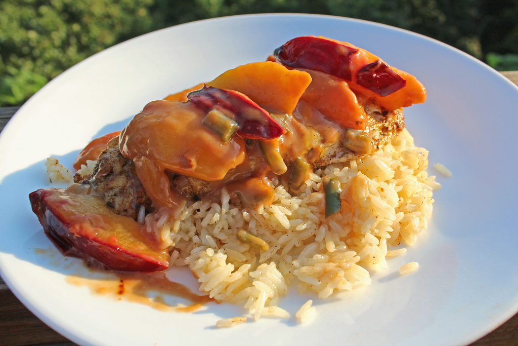 Jerk Chicken with Spicy Peach and Plum Coconut Sauce on a plate over rice
