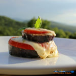 Roasted Eggplant Caprese Stacks on a plate ready to eat with mountain view