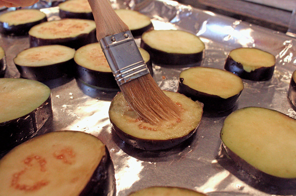 brushing eggplant slices with oil