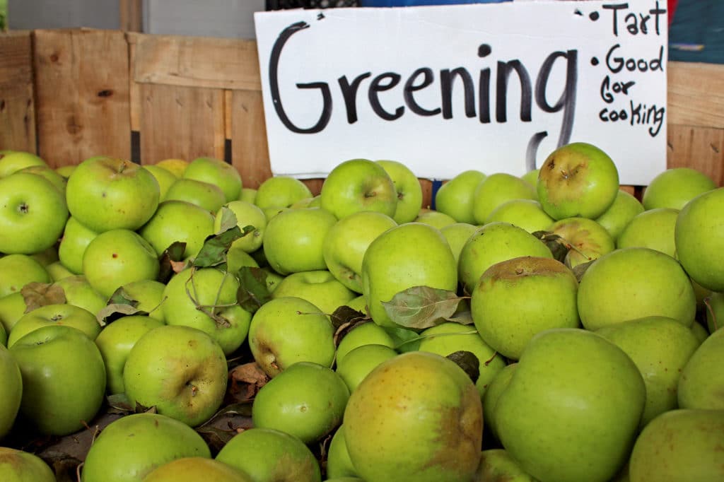 crate of greening apples