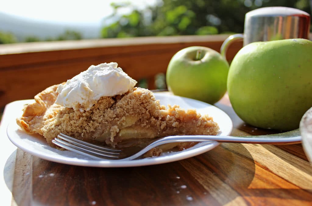 slice of apple crumb pie ready to eat