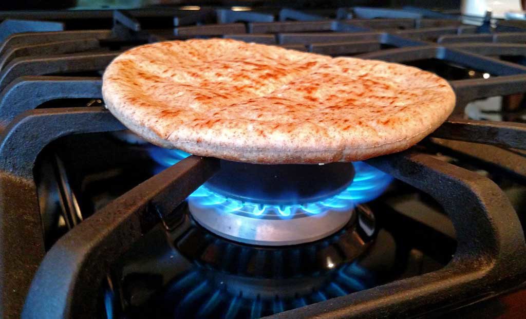 grilling pita bread on gas stove burner