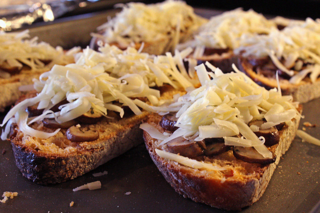 shredded cheese on bread and mushrooms