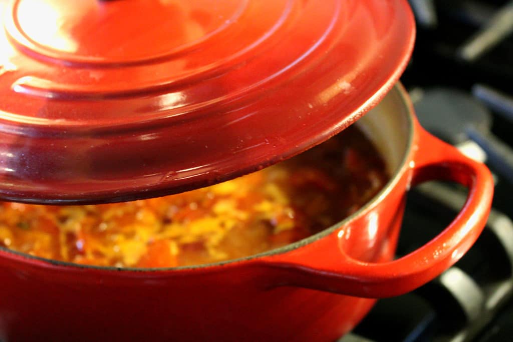 pot on stove full of Cajun pasta and andouille sausage on stove