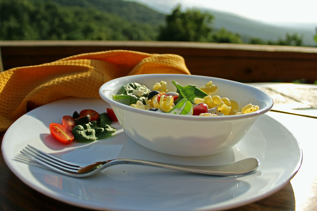 a bowl of pasta salad with mountain view