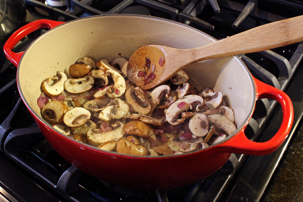 spoon with mushrooms in pot