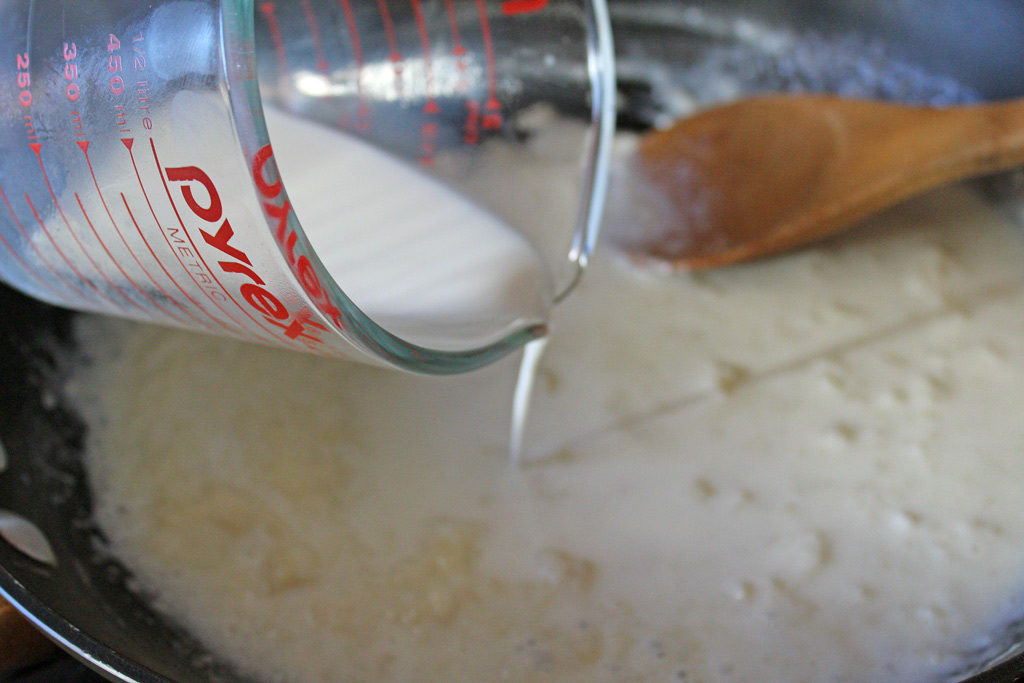 pouring milk into skillet
