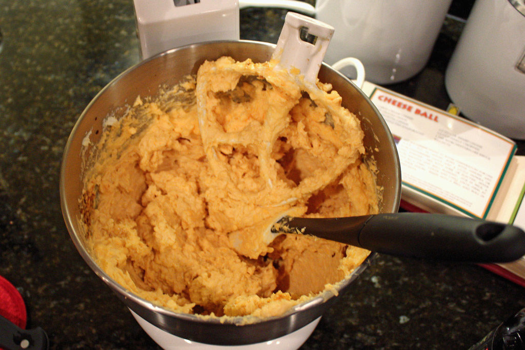 cheese in mixer bowl with paddle attachment and spatula