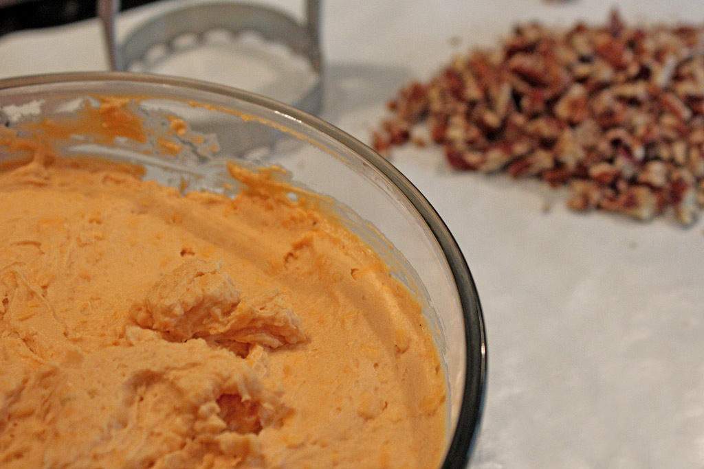 cheese in bowl with chopped pecans on butcher paper