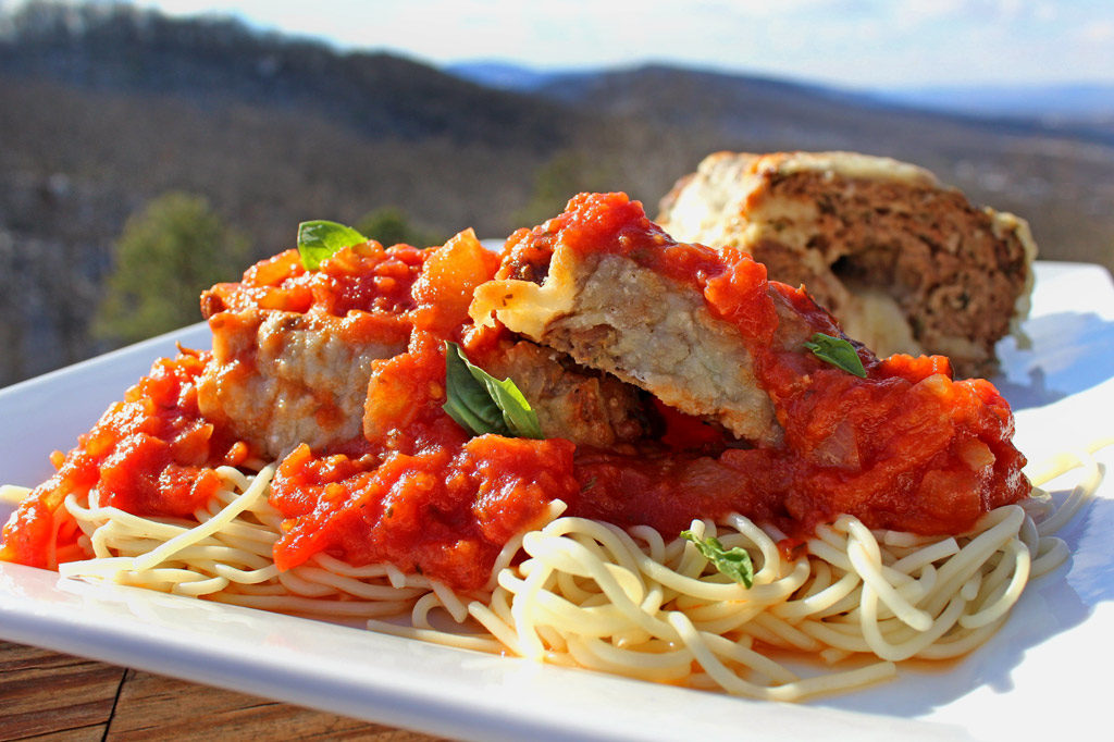 Italian meatloaf on plate with mountain view