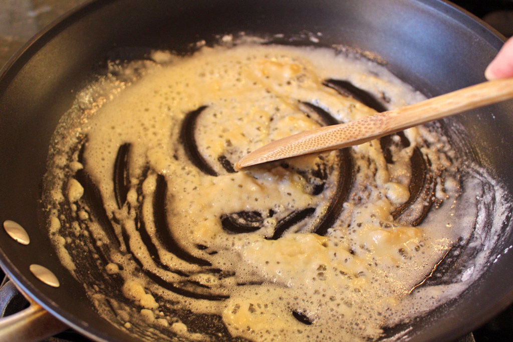 spoon stirring roux in skillet