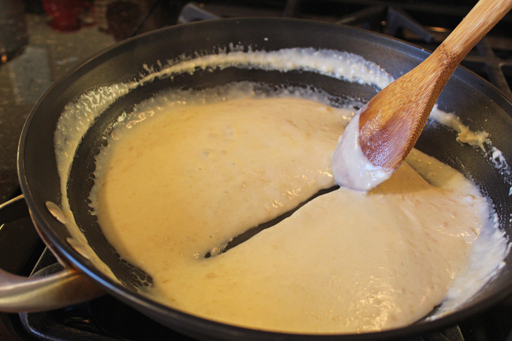 spoon separating sauce in skillet