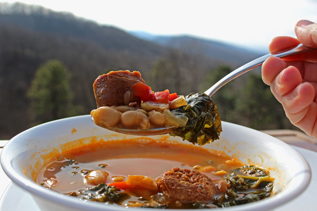 spoonful of Spanish-Style White Bean Soup with mountain view