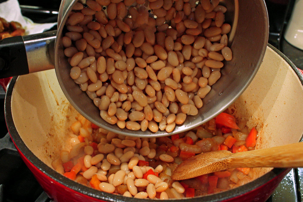 adding white beans to pot