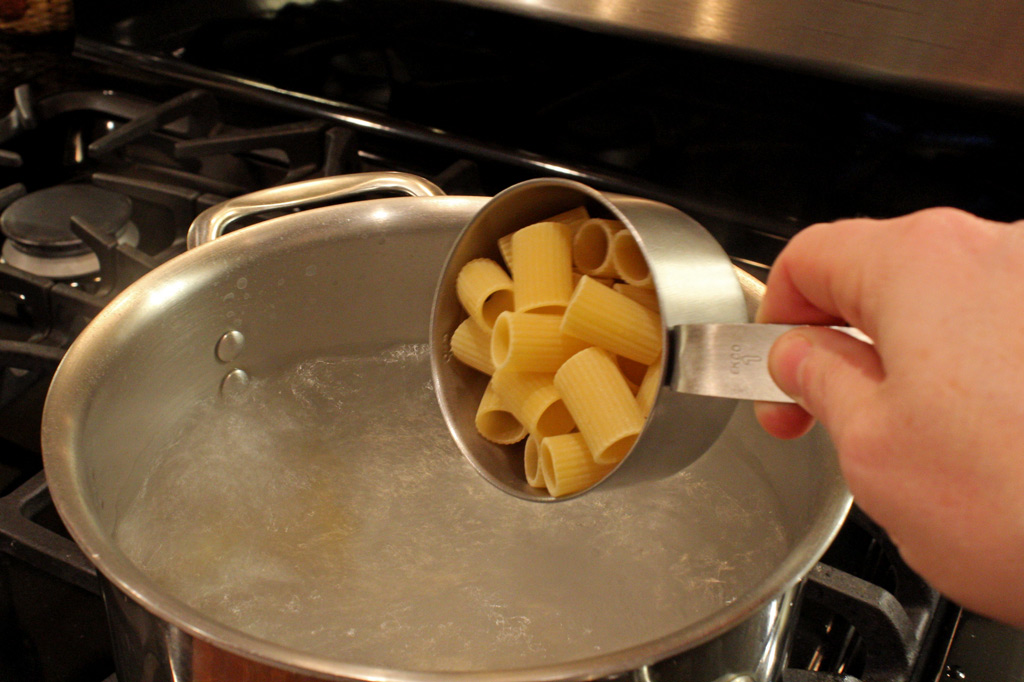 adding pasta to salty boiling water