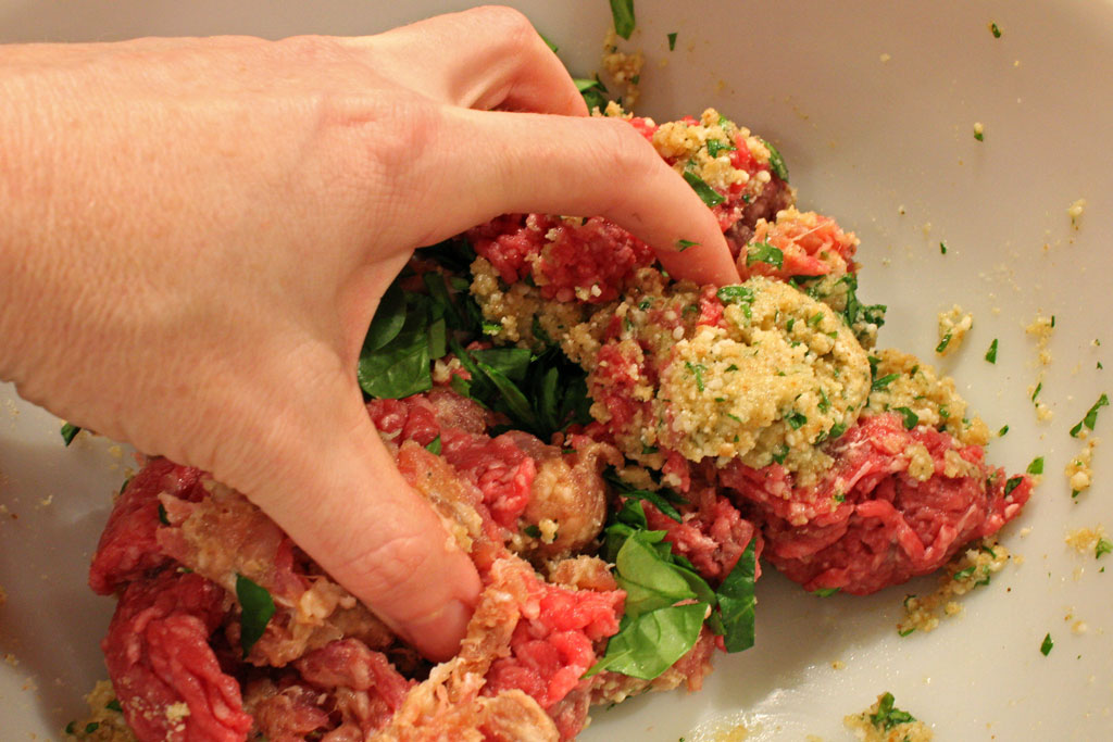 mixing meatball mixture with hands