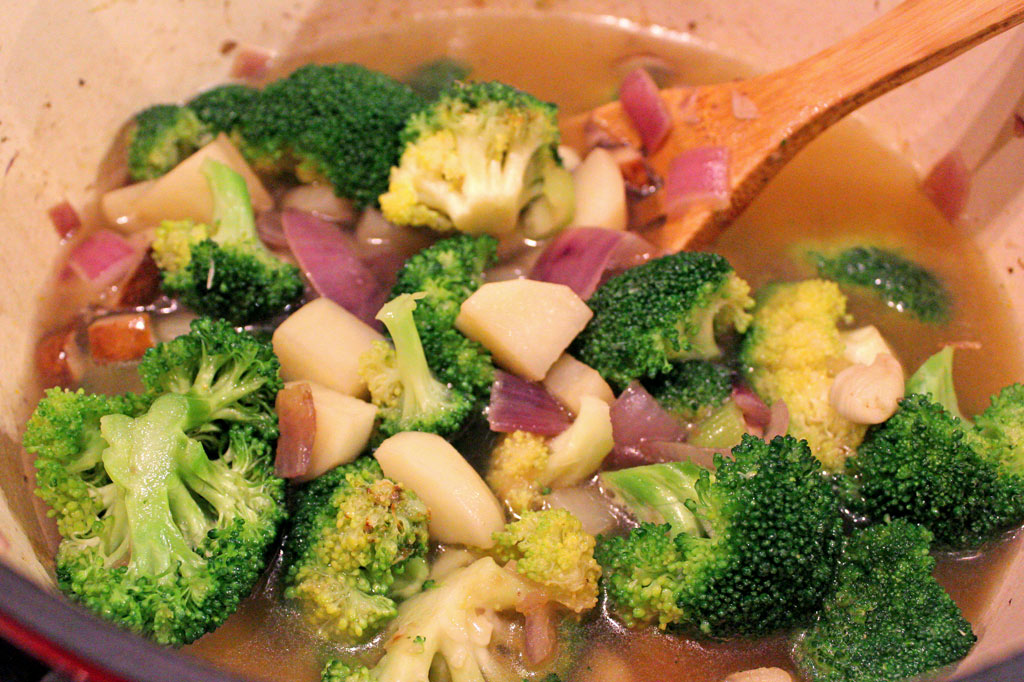 stirring soup in pot