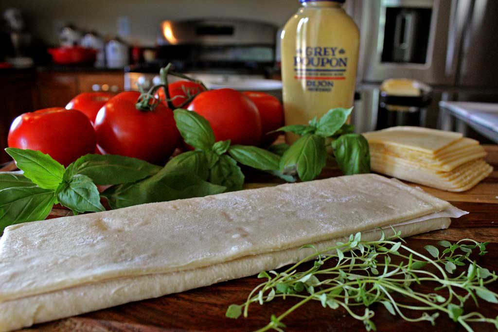 Roasted tomato cheese tart: puff pastry, ripe tomatoes Dijon mustard, smoked Gruyere cheese, simply seasoned with fresh thyme, fresh basil, salt and pepper. | TheMountainKitchen.com