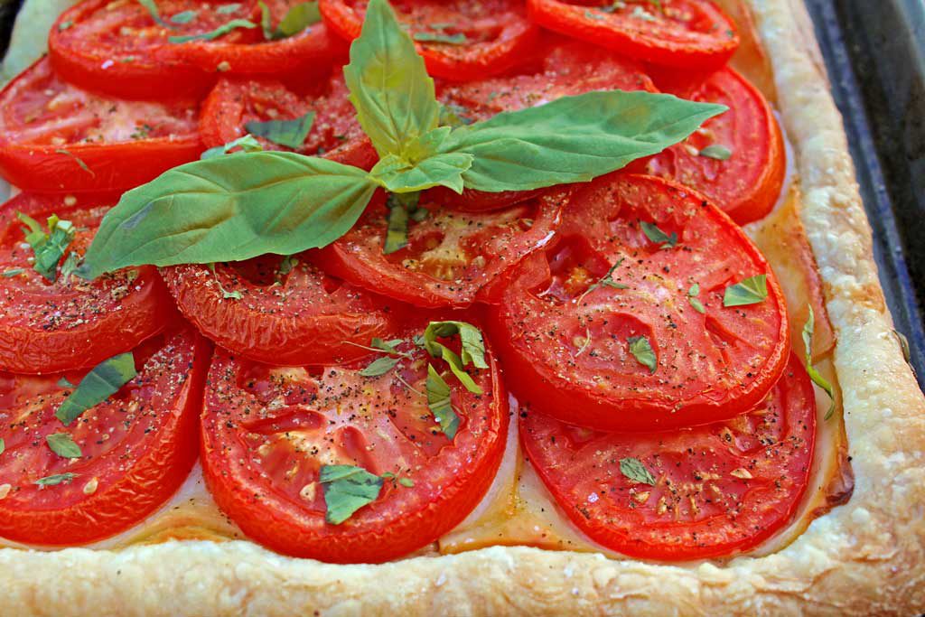 Roasted tomato cheese tart: puff pastry, ripe tomatoes Dijon mustard, smoked Gruyere cheese, simply seasoned with fresh thyme, fresh basil, salt and pepper. | TheMountainKitchen.com