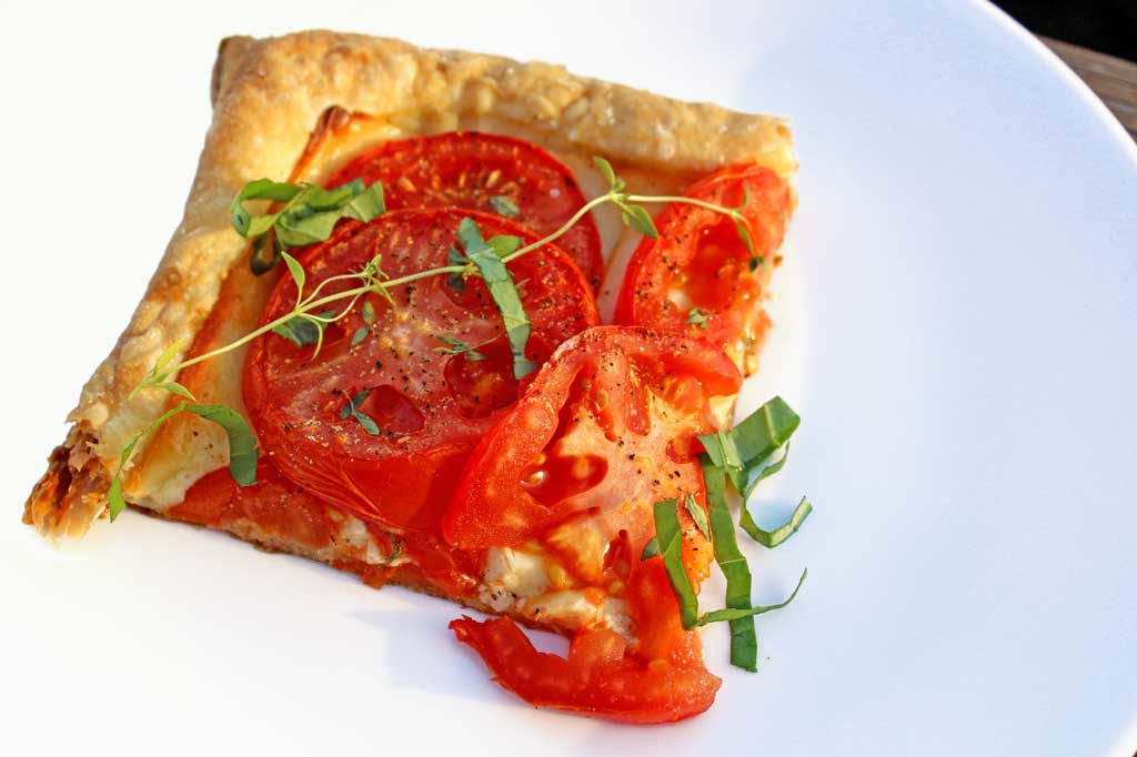 Roasted tomato cheese tart: puff pastry, ripe tomatoes Dijon mustard, smoked Gruyere cheese, simply seasoned with fresh thyme, fresh basil, salt and pepper.