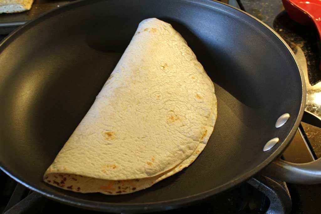 folded quesadilla in pan