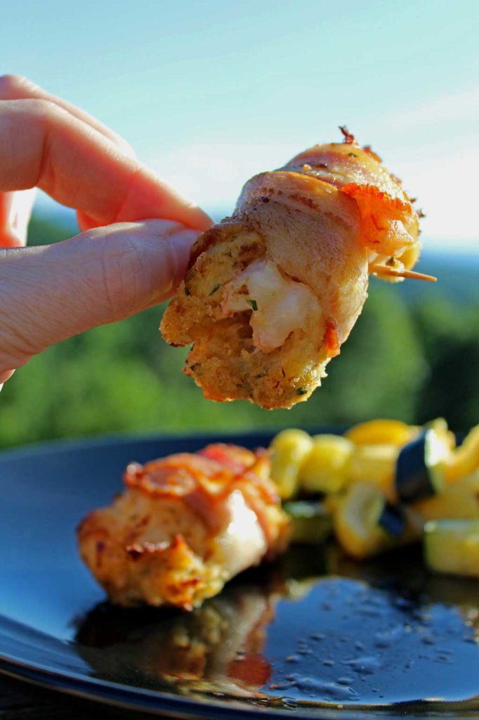 fingers holding up stuffed shrimp