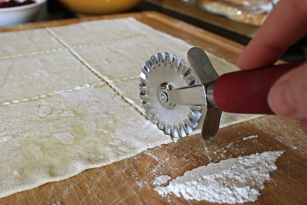 pastry wheel cutting dough