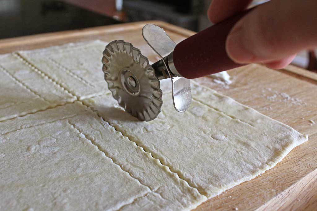 pastry wheel cutting dough