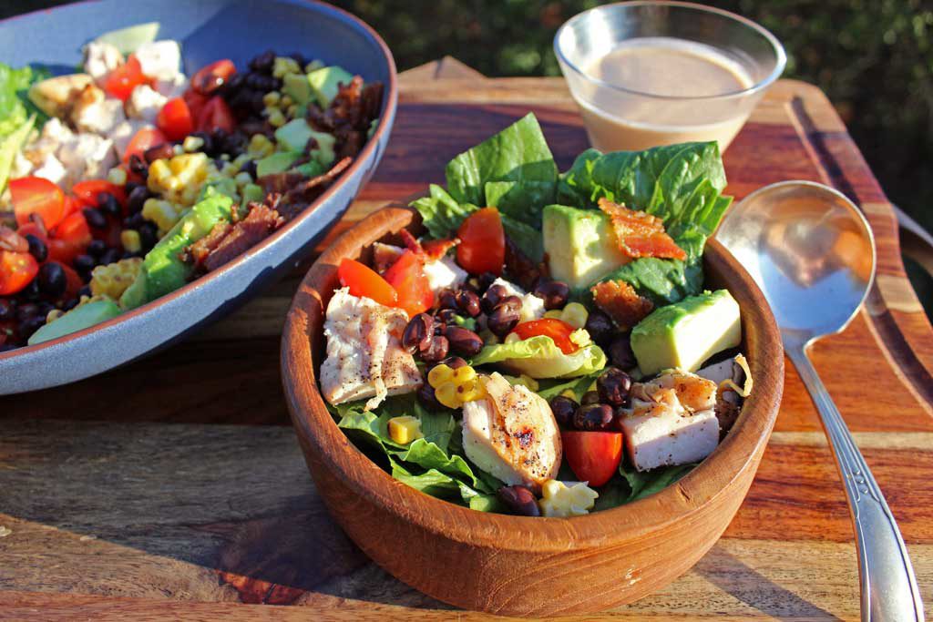 This Grilled Chicken Southwest Salad is packed with black beans, tomatoes, grilled corn, bacon, avocado and romaine lettuce, topped with BBQ Ranch Dressing.