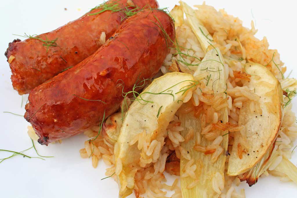 sausage apples and fennel with rice on plate