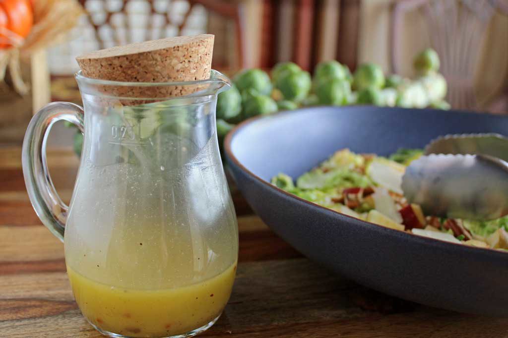 This apple pecan brussels sprout salad is for crunch lovers! Made with shredded brussels sprouts, apples, pecans, parmesan cheese and homemade dressing. | TheMountainKitchen.com