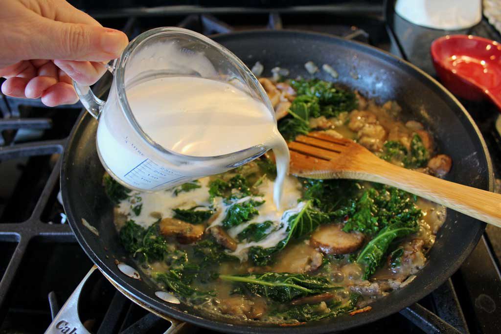 pouring the half-n-half into the pan