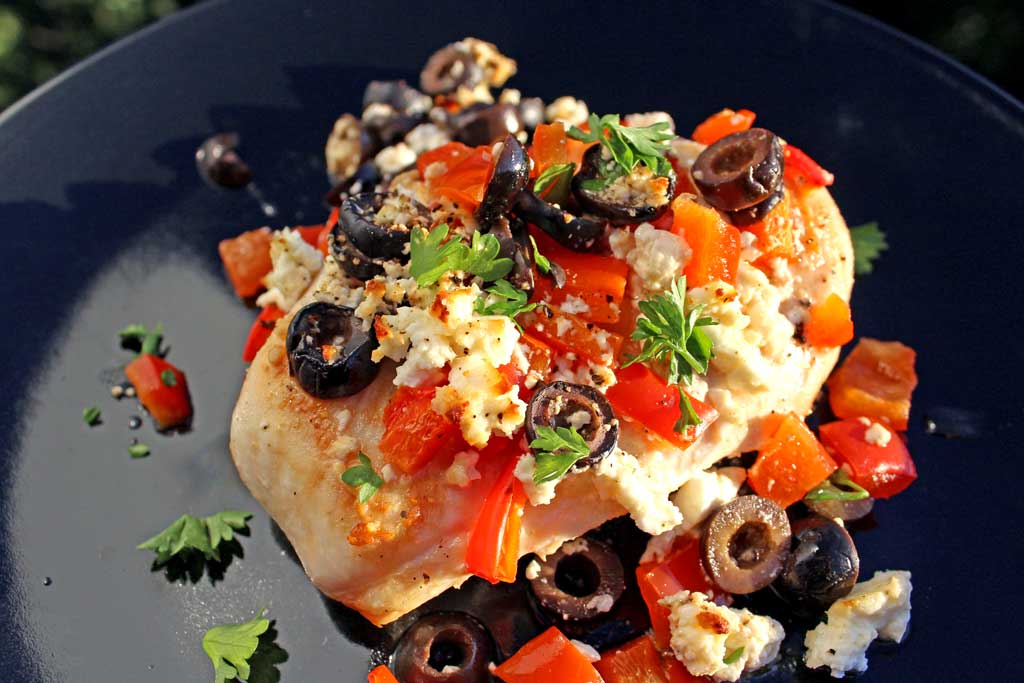 Quick and easy, the chicken breasts in this Mediterranean Chicken dish are basted in lemony broth with red bell peppers, black olives and tangy feta cheese.