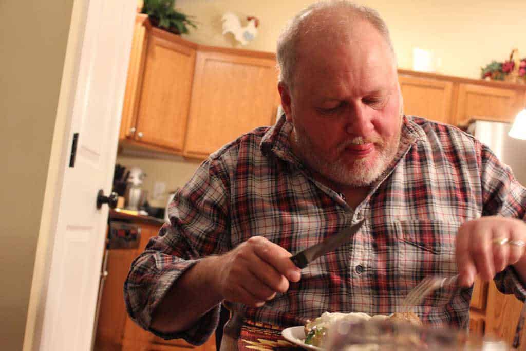 David licking his lips at supper table
