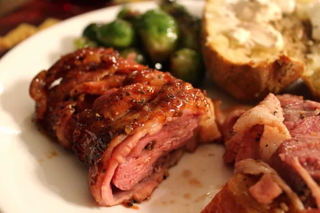 smoked venison on plate with sides