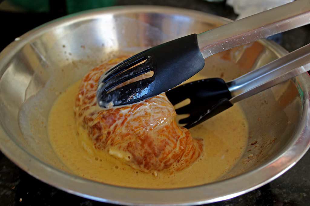 dipping croissant into custard